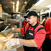 TimesCall > Chris Cisneros prepares an order during a training session at Taco John's in Longmont on Monday, Jan. 21, 2013. 
(Greg Lindstrom/Times-Call)
